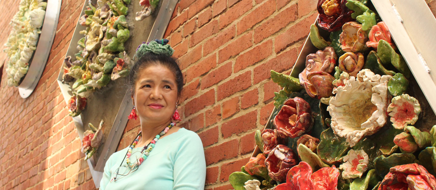 Tomiyo, an Envision Art participant, stands by her scuplture displayed at the Gallery Alley in downtown Wichita.